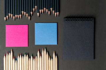pencils white and black with pink and blue notes, black notebook. Mock up, copy space. ideas,...