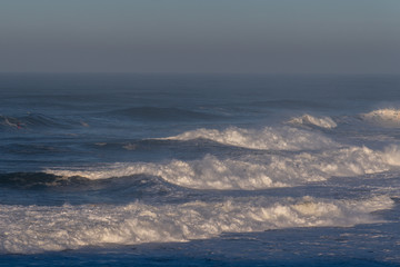Foamy Atlantic waves next to Nazare, Portugal.