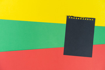 Black list Lithuania. Mourning, ban, sanctions. black sheet of notepad is on Lithuanian flag. Mock...