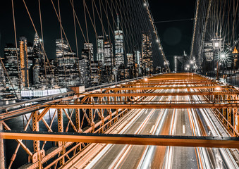 direct on view of long exposure traffic on the Brooklyn Bridge with lower Manhattan