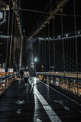 Brooklyn Bridge couple walk along bridge