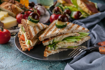Close-up toasts with scrambled eggs, vegetables and cheese. Tomatoes and spices. Delicious breakfast or snack