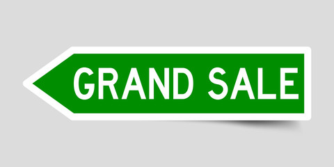 Arrow shape green color sticker in word grand sale on gray background