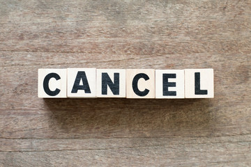 Fototapeta premium Letter block in word cancel on wood background