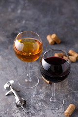 Glasses of white and red wine. The concept of winemaking. Place under your text. Still life on a textural background.