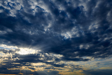 Beautiful sunset - dark sky with clouds and sunlight