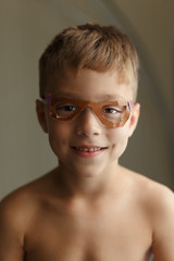 Boy posing in paper glasses