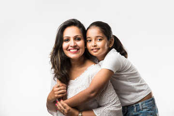 Indian mother daughter on white background hugging, kissing, riding, flying, pointing, presenting...