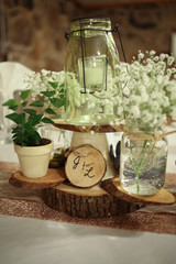 Wedding Photography Bridal Reception Table Centerpiece with Wood, Greenery, Candle in a Jar, and Baby's Breath