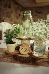 Wedding Photography Bridal Reception Table Centerpiece with Wood, Greenery, Candle in a Jar, and Baby's Breath