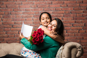 Mother's Day - Indian girl / mother celebrating Mother's day with Rose Flower Bouquet, greeting...