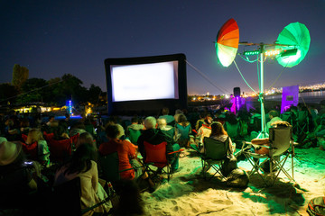 CINEMA ON THE BEACH AT NIGHT WITH STARS