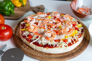 seafood pizza with shrimp on a table.