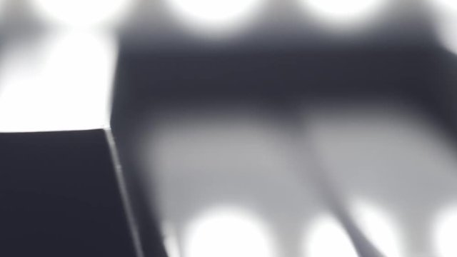 Slow right to left panning macro footage of the black keys on a piano or keyboard. 4k 30 frames per second shot.