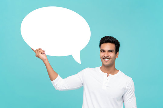 Handsome Indian man holding blank speech bubble