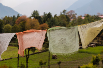 Flying colorful buddhist prayer flags with mantra waving in the wind near Phakding village in...