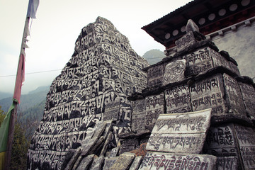 Mani Stones of Buddhism with six syllabled mantra Om Mani Padme Hum (means-Praise to the Jewel in...
