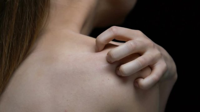 Depressed female victim on black background, psychological trauma, self-hatred