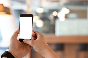 Man's hands using mobile phone with mockup montage screen.