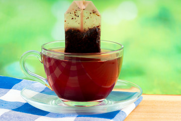 glass of tea on green background