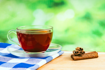 glass of tea on green background