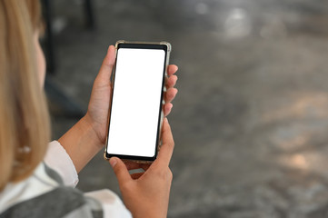 Young female using mobile phone with montage screen display.
