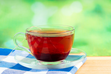 glass of tea on green background