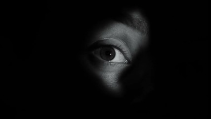 Curious female peeping into hole, invasion of privacy, detective investigation