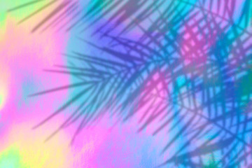 Trendy colored holographic background with palm leaves shadows in 90s style. Synthwave. Vaporwave style. Retrowave, retro futurism, webpunk