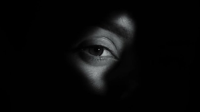 Female spy peeping through hole closing eyes, secret disappointment, betrayal