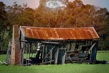 old derelict timber farm house abandoned in the countryside