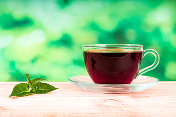 glass of tea on green background