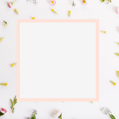 Festive flowers frame, composition on white background. Overhead top view, flat lay, square. Copy space.