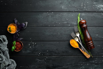 The background of cooking. On a black wooden background. Top view. Free space for your text.