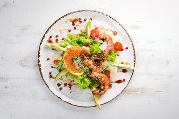 Salad with shrimp and avocado. In the plate. Rustic style. Top view. Free space for your text.