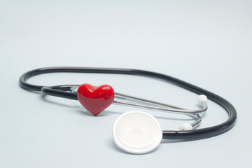 Concept on the topic of health. Stethoscope with a red heart on a light blue background.