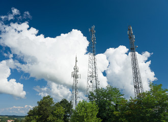 telecommunication tower on blue sky and white clouds 