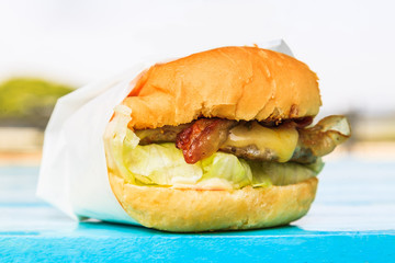Hamburger on a blue wooden table background