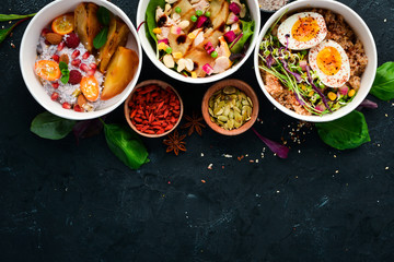 Food with delivery. A set of dishes for the diet. Top view. Free space for your text. On a black background.
