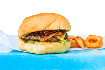 Hamburger with french fries on wooden table