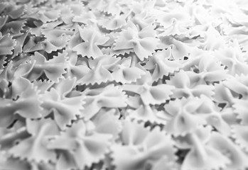 Fototapeta premium Pasta from durum wheat. Raw farfalle. Healthy food. Italian dishes.