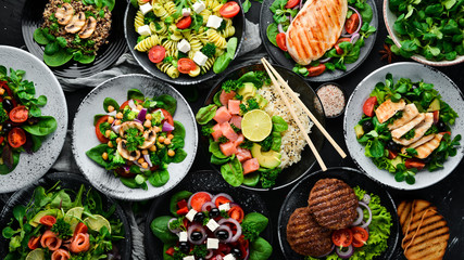 Assortment of food. Folk cuisine on a black wooden background Top view. Free space for your text. Flat lay