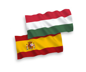 National vector fabric wave flags of Spain and Hungary isolated on white background. 1 to 2 proportion.