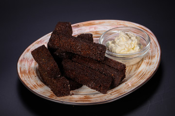 Black crouton with garlic sauce