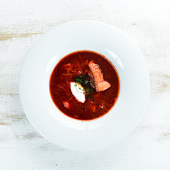Borsch. Beet soup. Ukrainian cuisine. On a wooden background. Top view. Free space for your text.