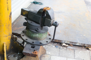 Old rusty vise for metal products. bench vise tool