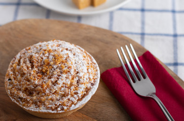 homemade cake with whipped cream and crushed nuts
