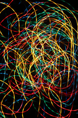 multicolored blurred in abstract motion light lines on a dark background. holiday mix show