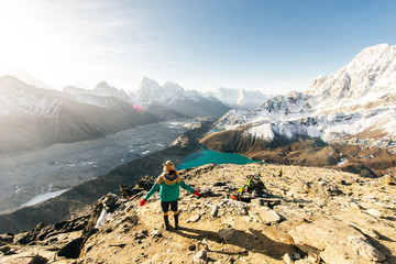 Female Tourist Hikking at gokyo ri mountain peak near gokyo lake during Everest base camp trekking in nepal