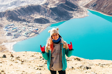 Female Tourist Hikking at gokyo ri mountain peak near gokyo lake during Everest base camp trekking in nepal